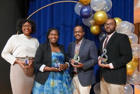 Recipients of the Black In STEM Award pose with their trophies.